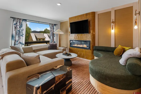 a living room with furniture and a flat screen tv