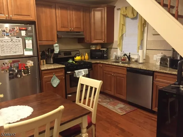 a kitchen with a table chairs sink and cabinets