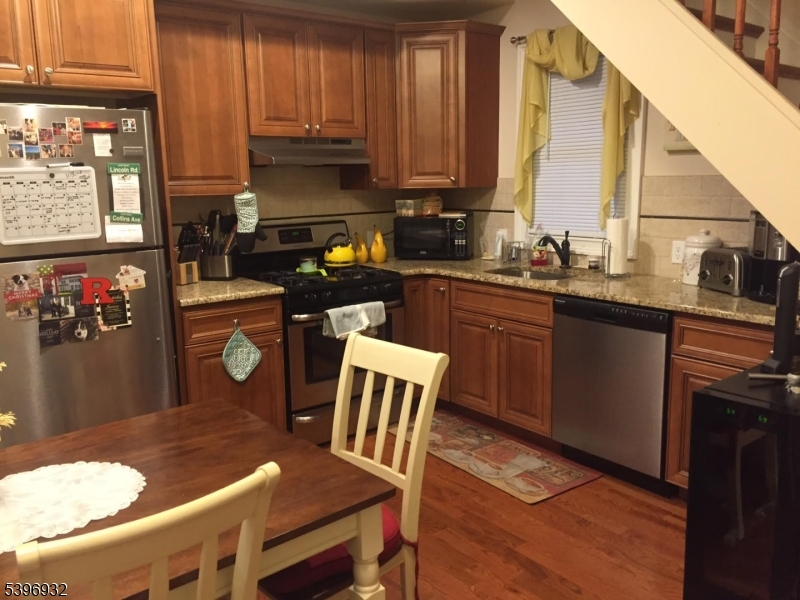 459 Main Street Metuchen, NJ 08840 - Photo 8 of 15 a kitchen with a table chairs sink and cabinets
