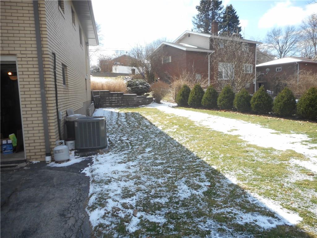 1183 La Salle Road Monroeville, PA 15146 - Photo 14 of 19 Tree lined rear yard with retaining wall on side