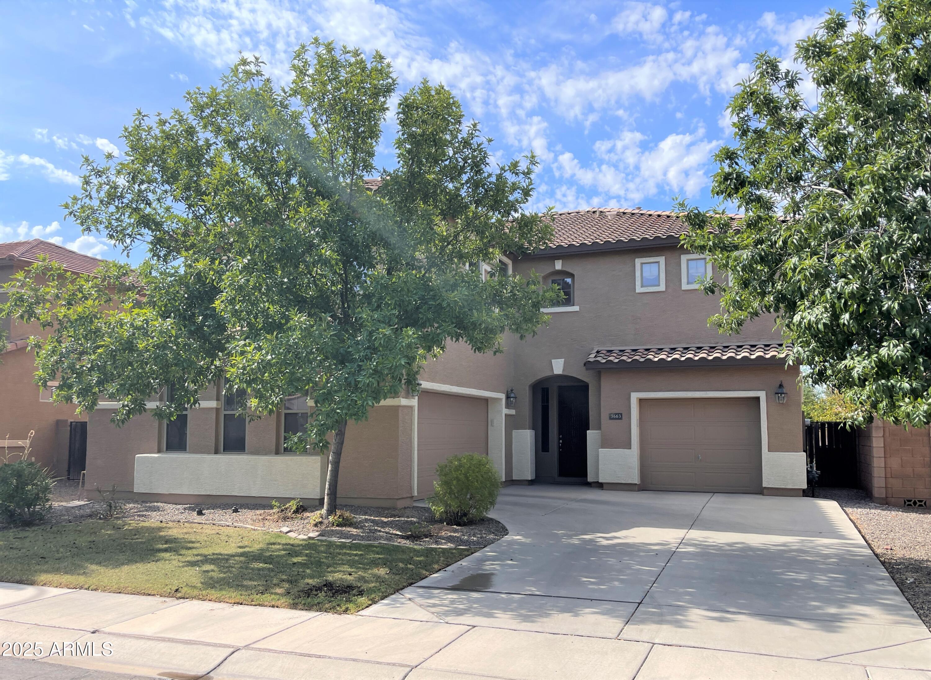 3663 East Sparrow Place Chandler, AZ 85286 - Photo 1 of 32 a front view of a house with a garden and trees