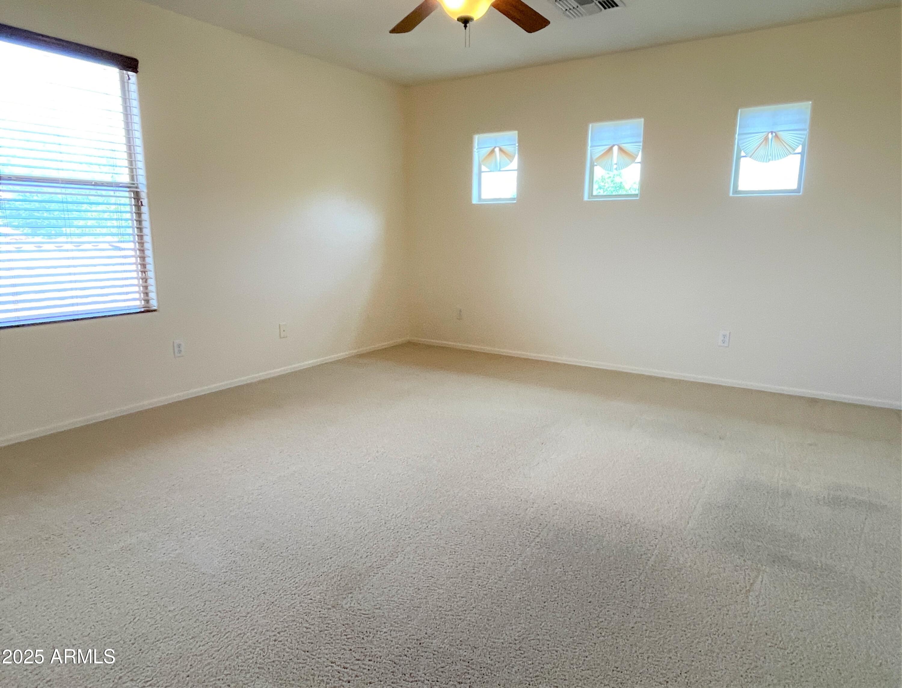 3663 East Sparrow Place Chandler, AZ 85286 - Photo 12 of 32 an empty room with windows and chandelier fan