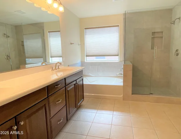 a bathroom with a tub sink and mirror