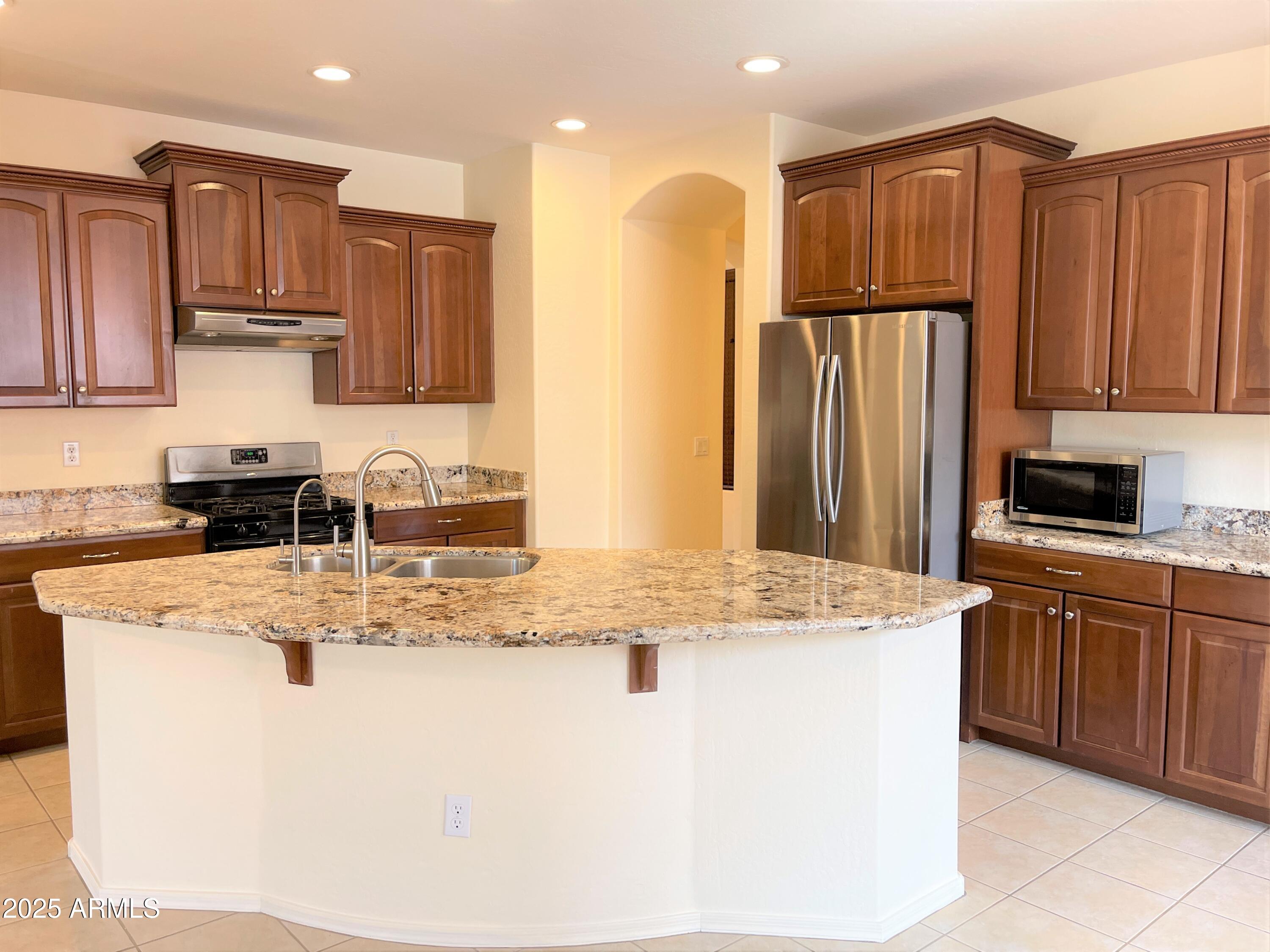 3663 East Sparrow Place Chandler, AZ 85286 - Photo 3 of 32 a kitchen with stainless steel appliances granite countertop a granite counter tops and white cabinets