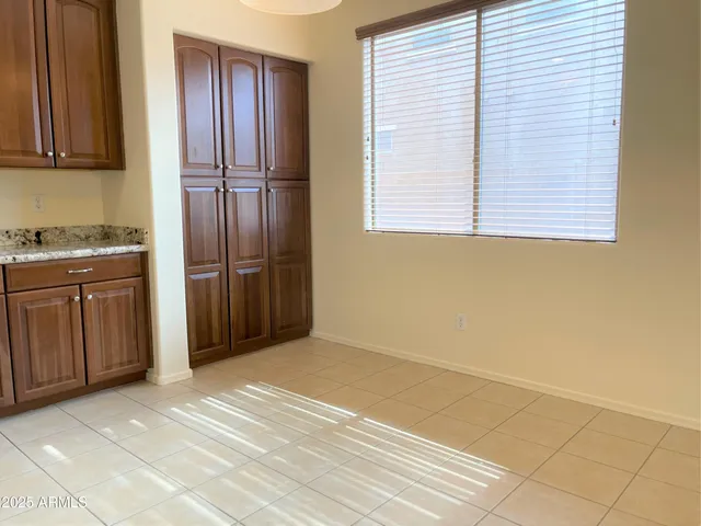 a view of a kitchen with wooden cabinet
