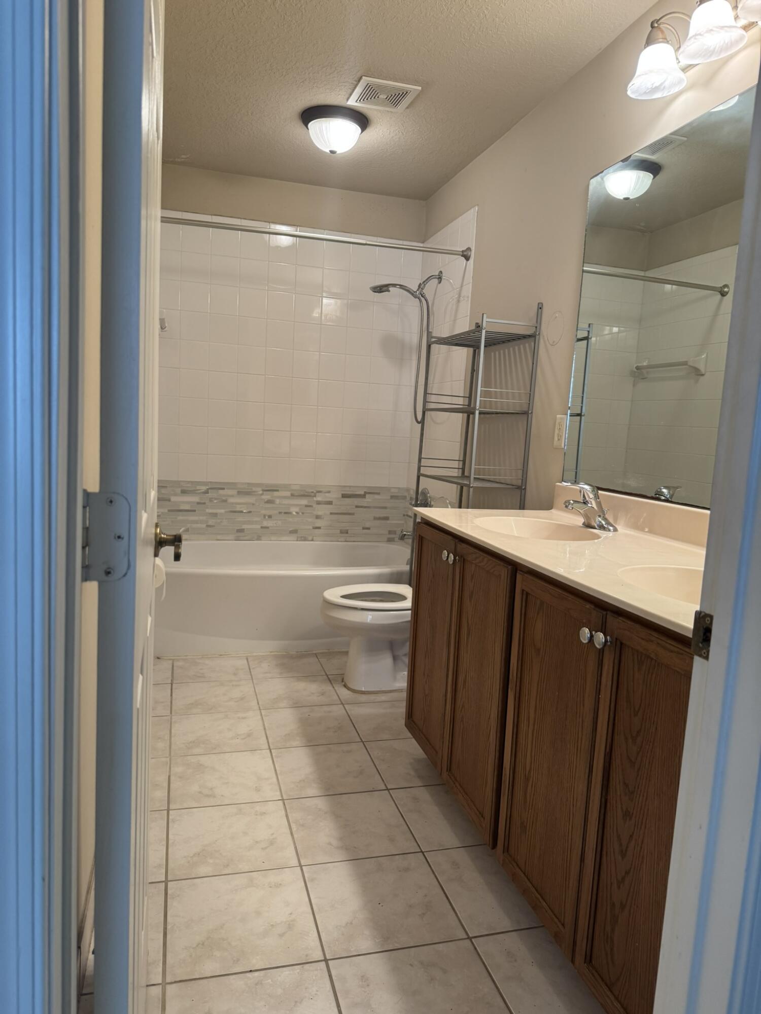 9107 Chambers Street, Unit 9107 Tamarac, FL 33321 - Photo 5 of 12 a bathroom with a sink a toilet and shower