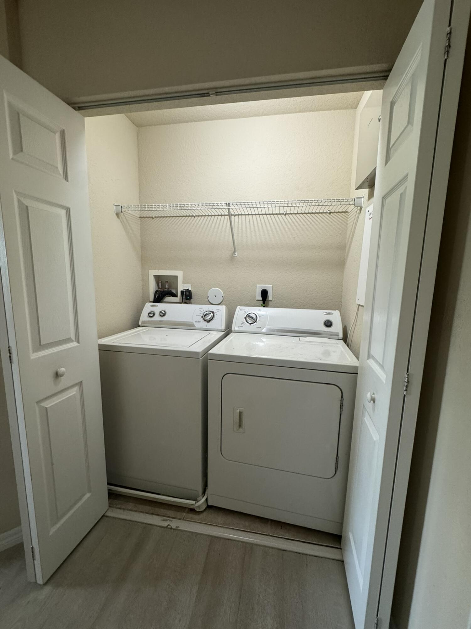 9107 Chambers Street, Unit 9107 Tamarac, FL 33321 - Photo 7 of 12 a utility room with dryer and washer