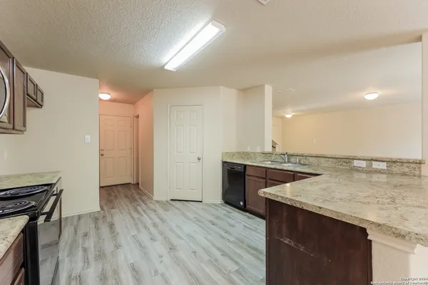 a kitchen with a sink and a refrigerator