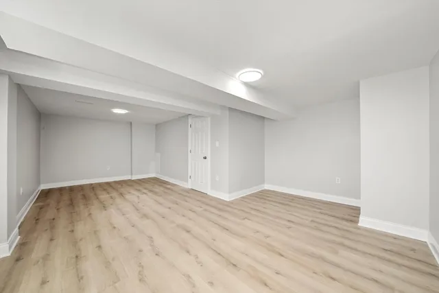 a view of an empty room and wooden floor