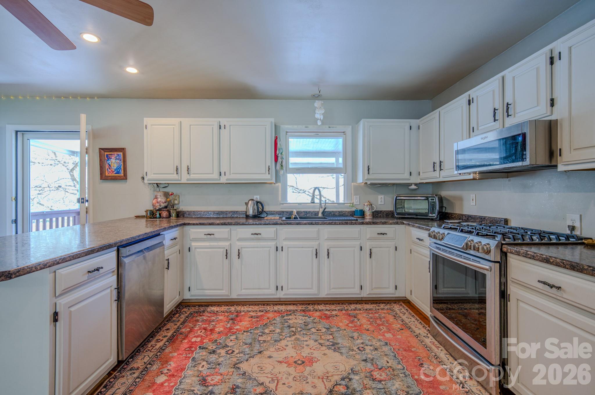 3 Taproot Trail Barnardsville, NC 28709 - Photo 18 of 48 a kitchen with stainless steel appliances granite countertop a stove sink and cabinets