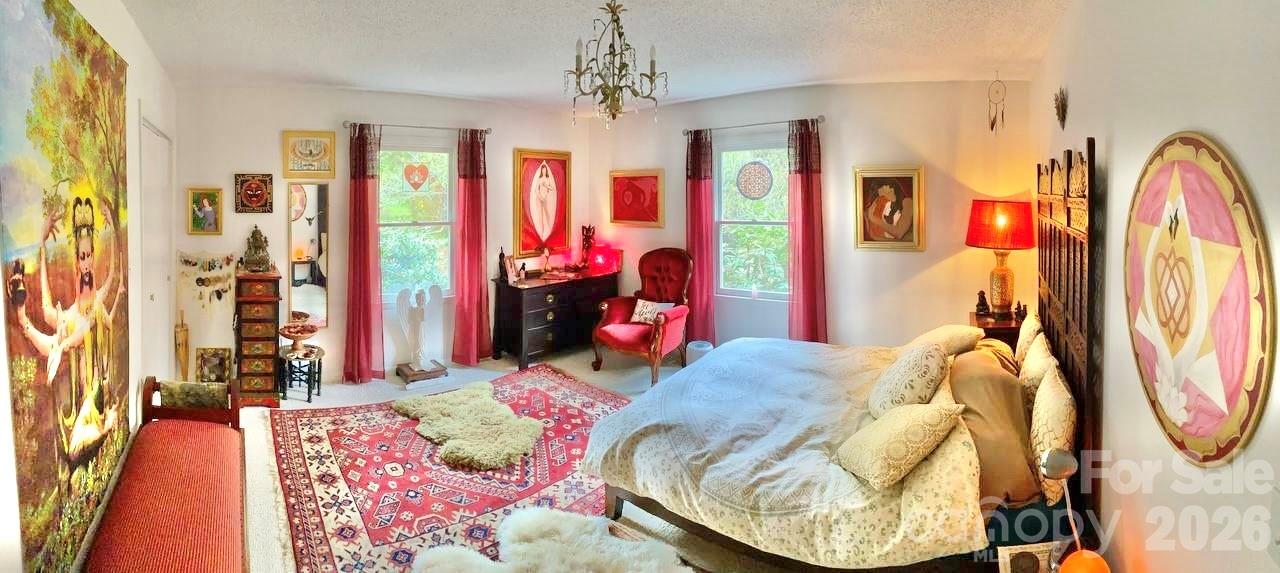 3 Taproot Trail Barnardsville, NC 28709 - Photo 21 of 48 a bedroom with furniture and a chandelier