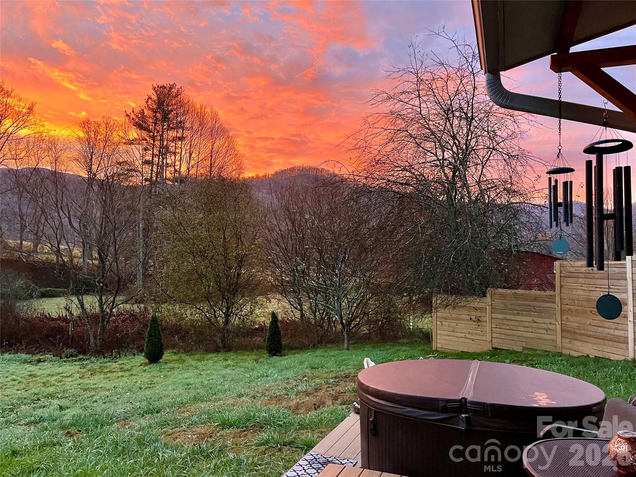 3 Taproot Trail Barnardsville, NC 28709 - Photo 35 of 48 a view of a backyard with table and chairs with a fire pit and a small yard