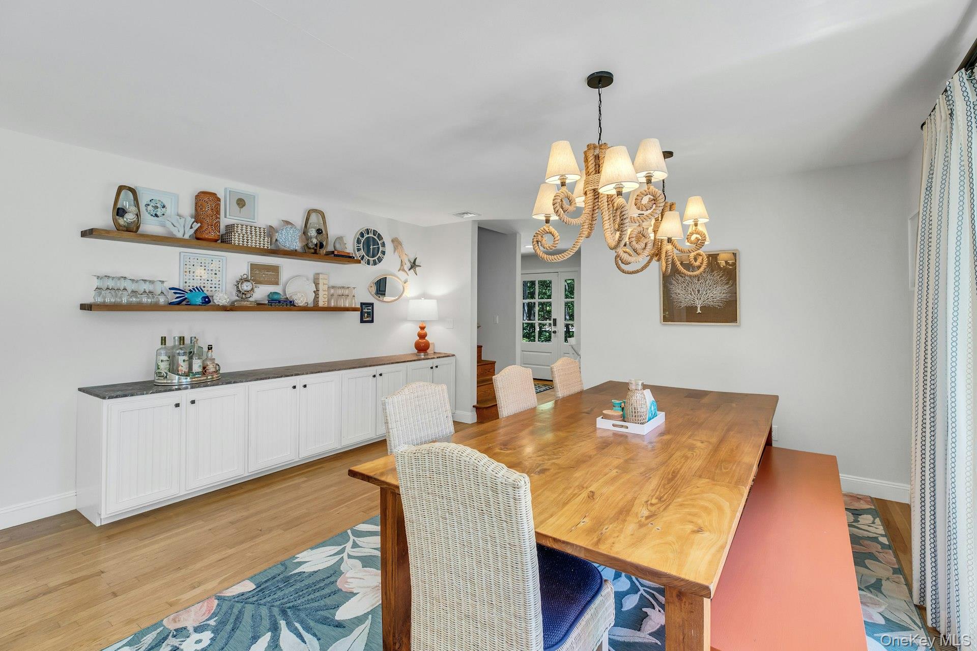16 Hildreth Road Hampton Bays, NY 11946 - Photo 13 of 29 a dining room with furniture and chandelier