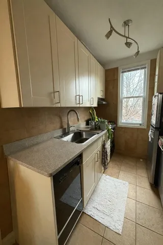 a kitchen with a sink stove and cabinets