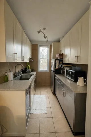 a kitchen with stainless steel appliances granite countertop a sink a stove and a refrigerator