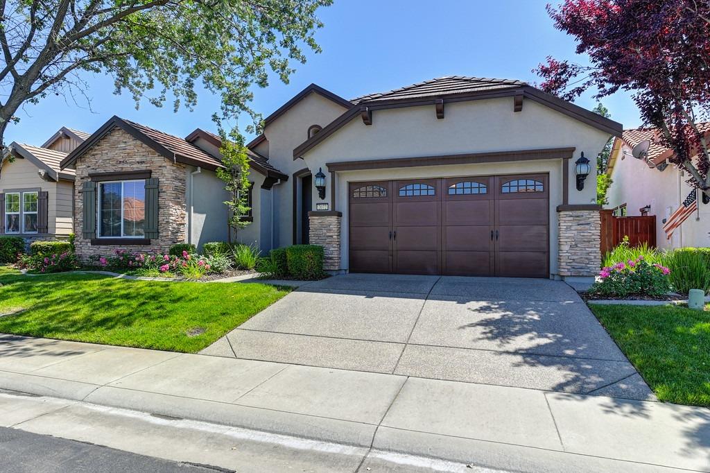 2072 Benton Loop Roseville, CA 95747 - Photo 1 of 1 a front view of a house with a garden and garage
