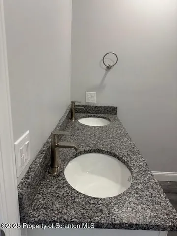a bathroom with a granite countertop sink and mirror