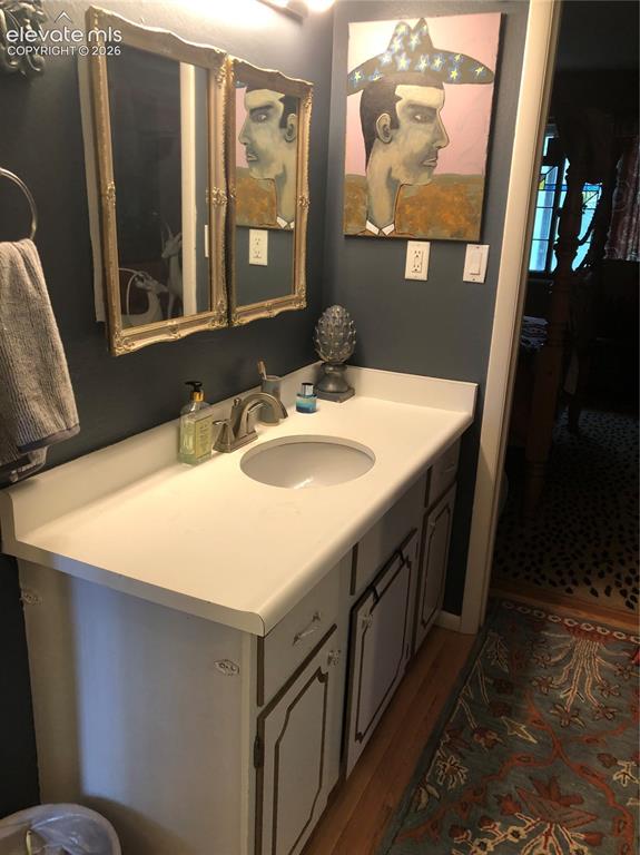2953 Mesa Road, Unit B Colorado Springs, CO 80904 - Photo 13 of 23 a bathroom with a sink and a mirror