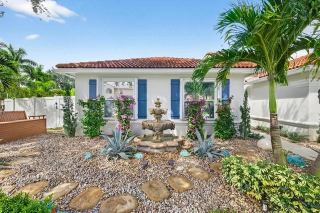 a view of a hallway with wooden floor and a chandelier