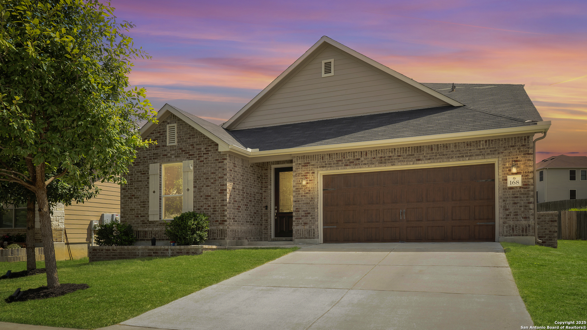 a front view of a house with a yard and garage