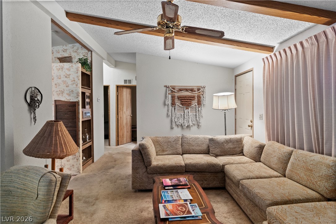 1609 Cajon Court Laughlin, NV 89029 - Photo 3 of 69 Carpeted living area with ceiling fan and beamed ceiling