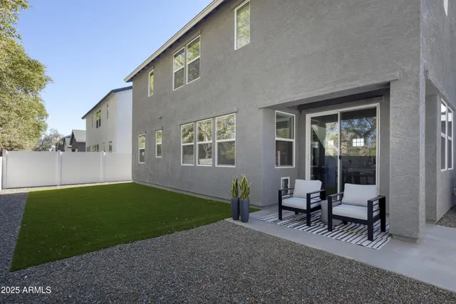 a view of a house with backyard and sitting area