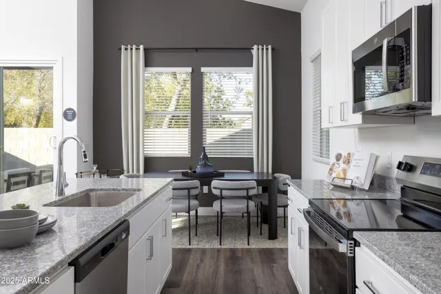 a kitchen with granite countertop a sink and a stove