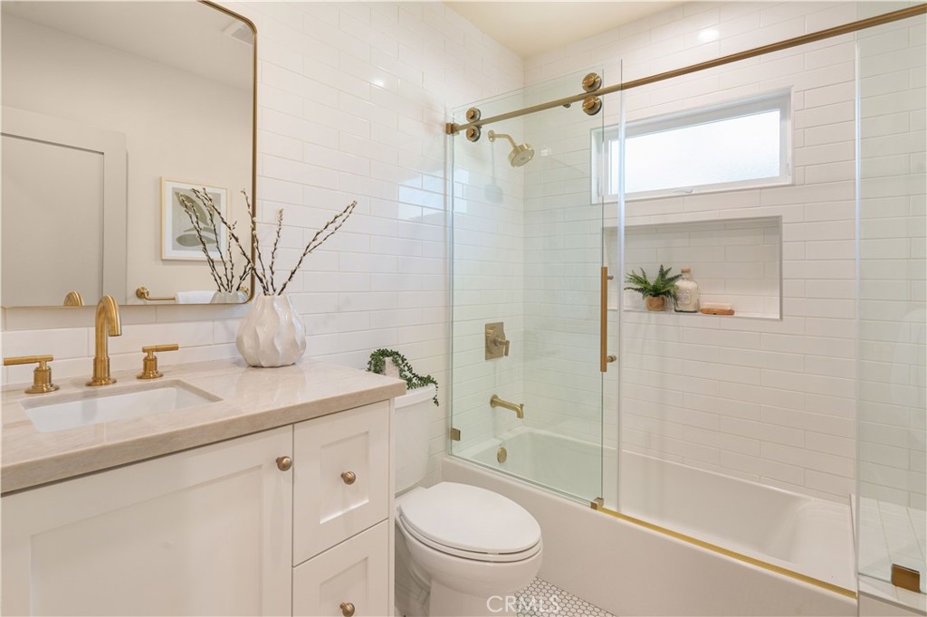 4245 East 6th Street Long Beach, CA 90814 - Photo 15 of 27 a bathroom with a granite countertop sink toilet and shower