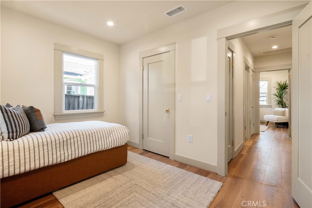 4245 East 6th Street Long Beach, CA 90814 - Photo 17 of 27 a living room with a bed furniture and a window