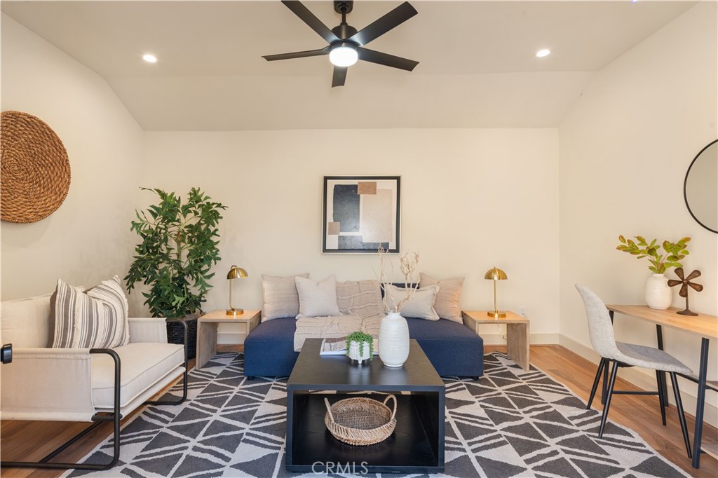 4245 East 6th Street Long Beach, CA 90814 - Photo 21 of 27 a living room with furniture and a rug