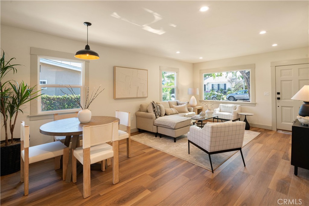 4245 East 6th Street Long Beach, CA 90814 - Photo 7 of 27 a living room with furniture a window and a chandelier