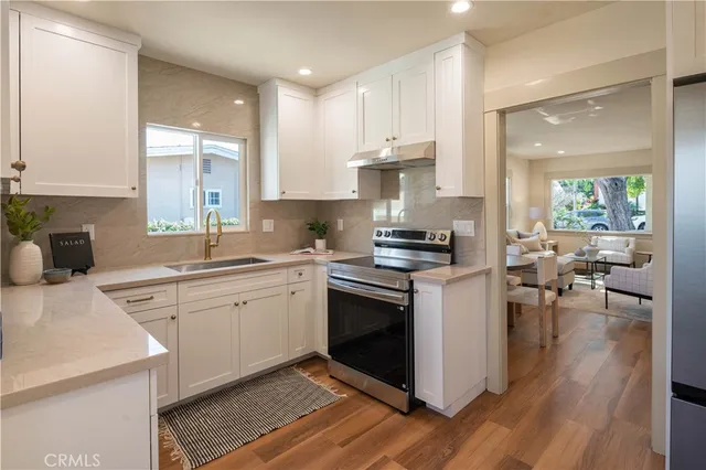 a kitchen with a sink cabinets and wooden floor
