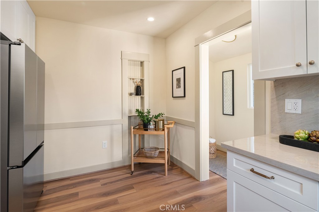 4245 East 6th Street Long Beach, CA 90814 - Photo 10 of 27 a kitchen with a refrigerator and table