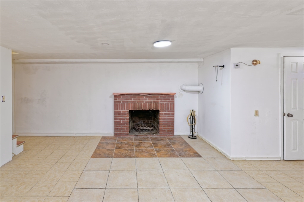 1 Rockland Rd Court Auburn, MA 01501 - Photo 24 of 38 a view of an empty room with a fireplace and a window