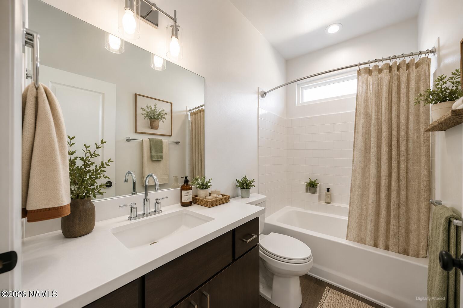 10272 Fw Mclure Road Flagstaff, AZ 86004 - Photo 12 of 38 a bathroom with a sink a toilet a mirror a vanity and shower