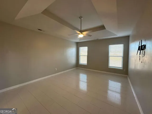 an empty room with a empty space and a ceiling fan