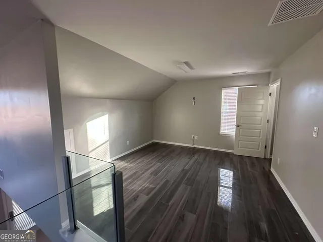 a view of room with wooden floor