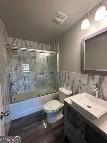 a view of kitchen with furniture and wooden floor