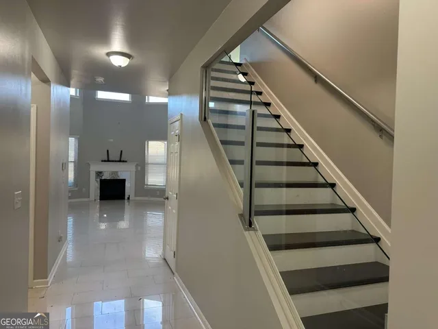 a view of entryway and hall with wooden floor
