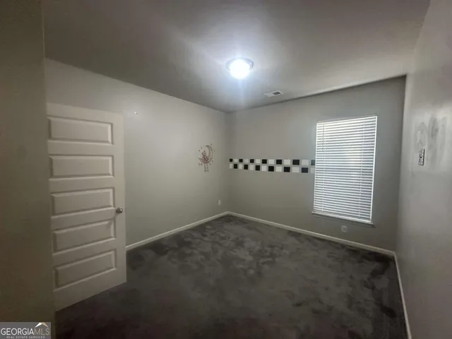 a view of an empty room and a window