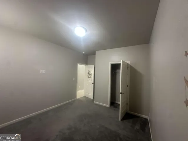 an empty room with closet area