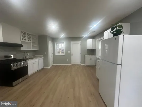 a kitchen with granite countertop a stove and cabinets