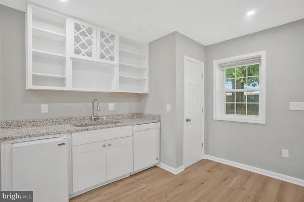 a kitchen with a sink cabinets and a window