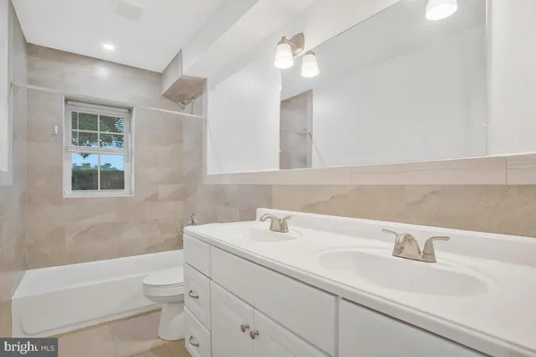 a bathroom with a sink a toilet and a bathtub