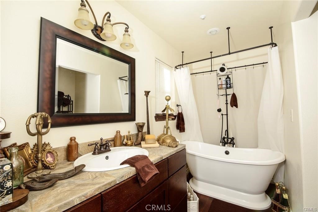 a bathroom with a granite countertop sink a toilet and mirror