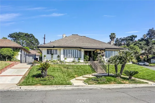 a front view of house with a garden