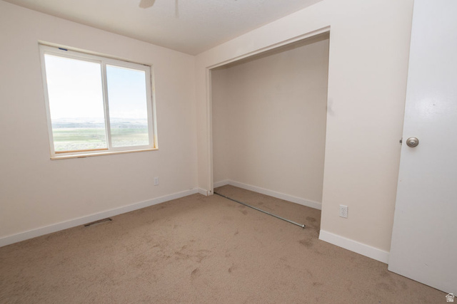 570 West Main Street Beaver, UT 84713 - Photo 15 of 43 Carpeted room featuring a large window, open closet space, white baseboards, and a white interior door