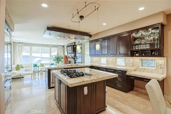 a kitchen with stainless steel appliances granite countertop a sink and a refrigerator