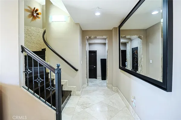 a view of entryway and hall with wooden floor