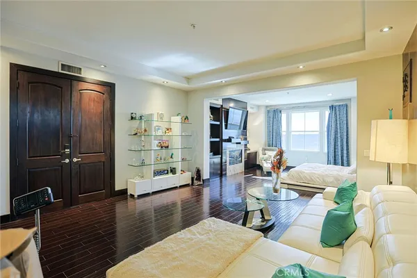 a living room with furniture and wooden floor